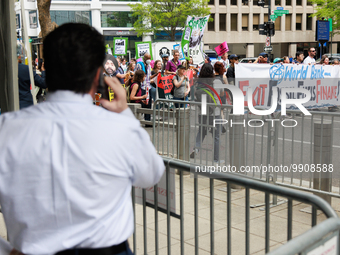A man speaks on his phone outside of the 2023 IMF-World Bank meetings in Washington, D.C. on April 14, 2023 as climate change demonstrators...