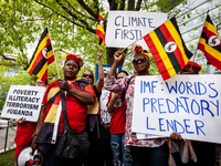 Ugandan protesters join climate activists in a rally and march at World Bank headquarters during its spring meetings with the International...