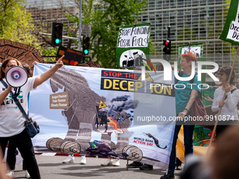 Climate activists participate in a rally and march at World Bank headquarters during its spring meetings with the International Monetary Fun...