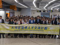 Healthcare Professionals participating in the Exchange Programme posing for a group photo inside the West Kowloon High Speed Railway station...