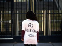 An activist wears a shirt reading 'Let's us rise up !' Three campaigners of  'Derniere Renovation' (ie 'Last Renovation') campaign painted i...