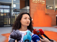 An activist speaks to the press after the painting of the entrance of the Conseil Regional Occitanie. Three campaigners of  'Derniere Renova...