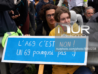 A protester holds a placard reading 'A69, it's no. A 69 why not ?' More than 8000 protesters marched 12km against the planned A69 highway. T...