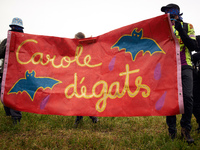 Protesters hold a banner reading 'Carole degats' a pun on 'Carole Delga, head of the Regional Council Occitanie who backs the A69 highway. M...