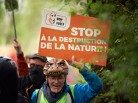 A protester holds a placard reading 'Stop to nature destruction'. More than 8000 protesters marched 12km against the planned A69 highway. Th...