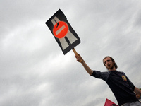 A protester holds a sign against the A69 highway. More than 8000 protesters marched 12km against the planned A69 highway. The collectives 'L...