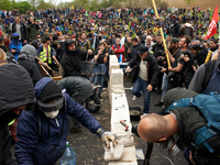 Protesters build a wall on the N126 during the protest. More than 8000 protesters marched 12km against the planned A69 highway. The collecti...