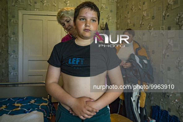 A kid is checked by a doctor of FRIDA NGO in Pisky Radkivski. FRIDA NGO is a crew of Israeli and Ukrainian medical volunteers who assist civ...