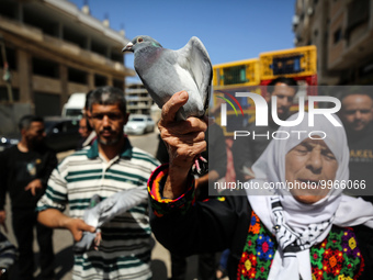 Palestinians take part in a pigeon homing event organised by local breeders outside the International Committee of the Red Cross (ICRC) buil...