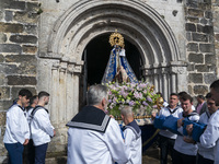 The participants with marine costumes, take out the figure of the virgin to begin The procession of La Folia with the virgin of the Barquera...