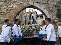 The procession of La Folia with the Virgin of La Barquera in its route through the streets of the town of San Vicente de la Barquera (Cantab...