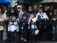 The public protected themselves from the rain with umbrellas during La Folia procession, with the Virgin of La Barquera, on his journey thro...