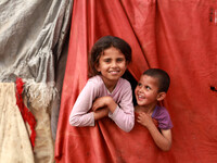 Palestinian children from the Bedouin by playing outside the family hut in Gaza City, on May 4, 2014.(