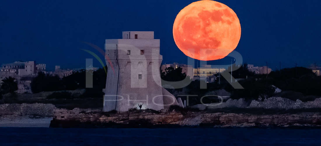 The fifth Full Moon of 2024, the Flower Moon, is appearing in Molfetta, Italy, behind Torre Calderina with a dancer, on May 22, 2024. Its na...