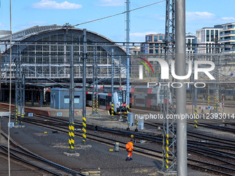 Track Labourer Crossing Rails At Station