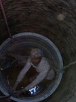 Migrant worker digging water well in Nepal