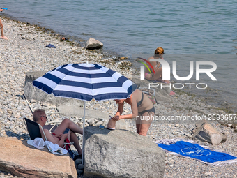 People Swimming And Sunbathing At Lake Constance