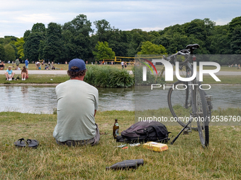 People Relaxing In The English Garden In Munich