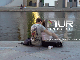 Young Couple By City River