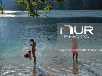 Young Man And Woman In Lake At Sunset