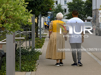 Migrant Caregiver With Elderly Woman