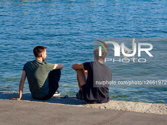 Two Young Men By Lake
