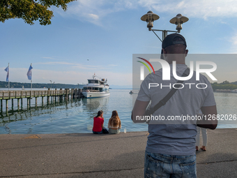 Man And Two Women At Lake