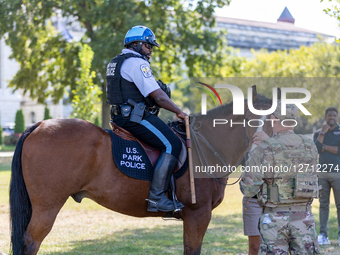 A U.S. Park Police Officer And Horse Patrol The National Mall And Greet National Guard Members