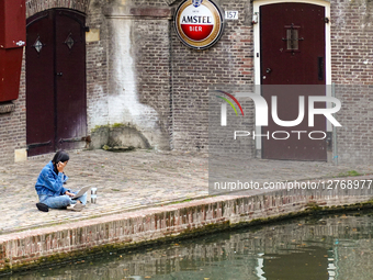 Woman Working With Laptop By Canal