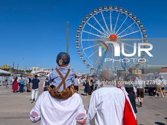 Visitors And Ferris Wheel At Oktoberfest