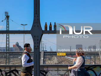 Two People In Traditional Clothing Passing On Bridge During Oktoberfest