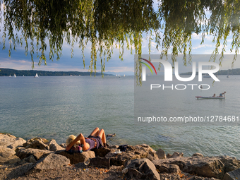 Woman Relaxing Alone At Lake