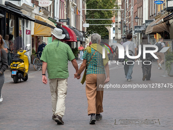 Couple Walking Hand In Hand In City