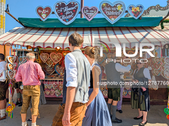 Couple Walking Past Gingerbread Heart Stall