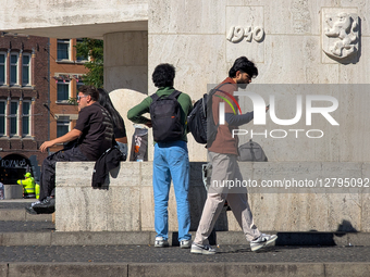 Man Walking With Smartphone And Man Talking Outdoors