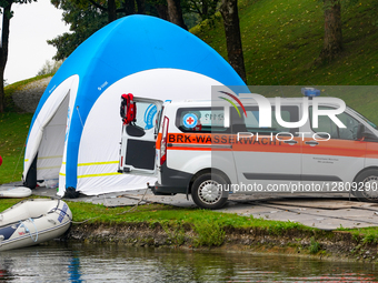 German Red Cross Water Rescue Paramedic At First Aid Tent With Rescue Boat And Vehicle