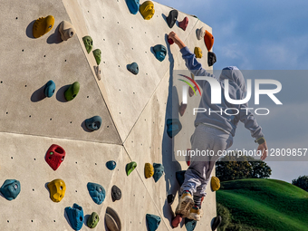 Boy Climbing On Outdoor Wall