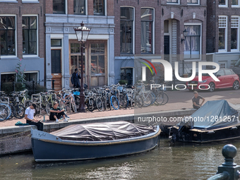 Youth At The Canal In Amsterdam
