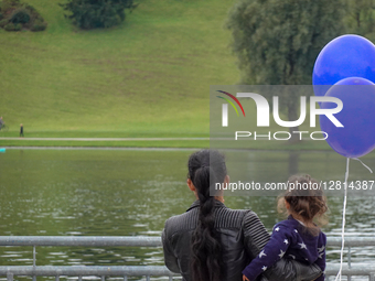 Woman With Child And Balloons By The Lake