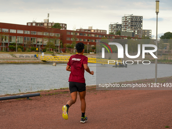 Young Jogger Running Along Riverside Path
