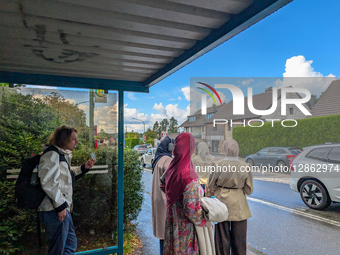 People Waiting At Bus Stop