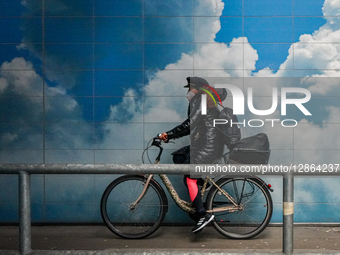 Woman Cycling Through Underpass