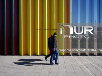 Men Walking Past Colorful Facade