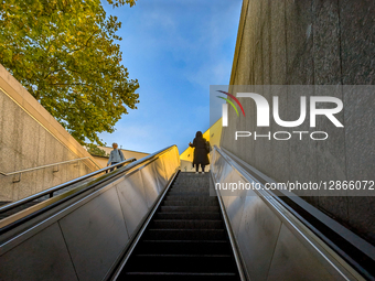 Women On Escalator At Subway Station Exit