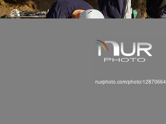 Skateboarder Adjusting Gear Before Ride