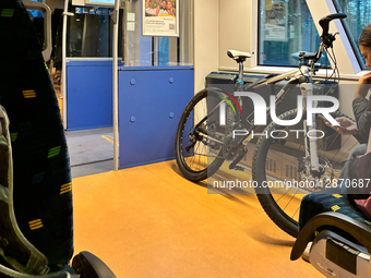 Passenger With Bicycle And Smartphone On Train