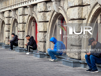 People Using Smartphones At Station