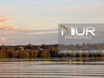 Rowers On Lake At Sunset