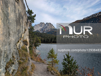 Couple Hikes Scenic Trail Above Lake Blindsee With Zugspitze Massif View
