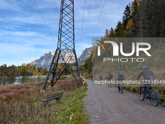 Group Of Cyclists Rides At Lake Weissensee In Tyrol